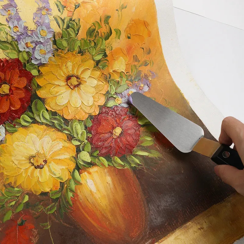 Espátula de pintura a óleo com lâmina de aço inoxidável e cabo de madeira.
Ferramenta artística para texturizar e misturar tintas em diferentes formatos.