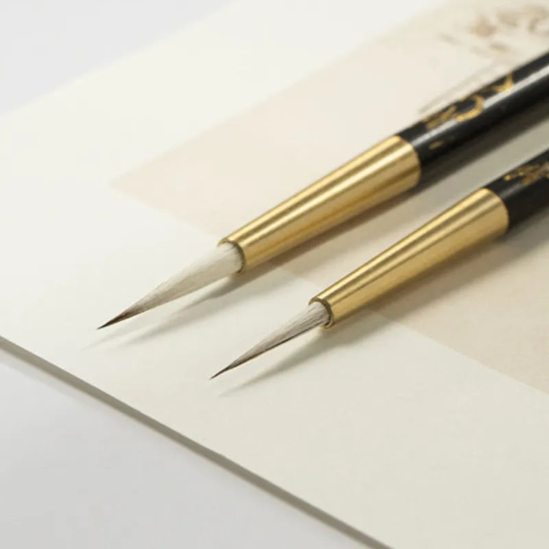 Pincel de linha fina para caligrafia com porta-pincel de ébano e latão.
Detalhe do pelo macio de lã e design ergonômico do pincel de caligrafia.
Pincéis de caligrafia em tamanhos pequeno e grande para escrita precisa.