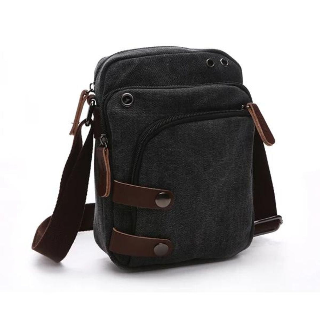 Bolsa de Ombro Masculina, confeccionada em lona resistente, sendo versátil para diversas ocasiões. Seu interior possui vários bolsos, incluindo um específico para celular, além de um espaçoso compartimento com fechamento em zíper. Com um estilo vintage, essa bolsa é perfeita para aqueles que buscam praticidade e estilo.