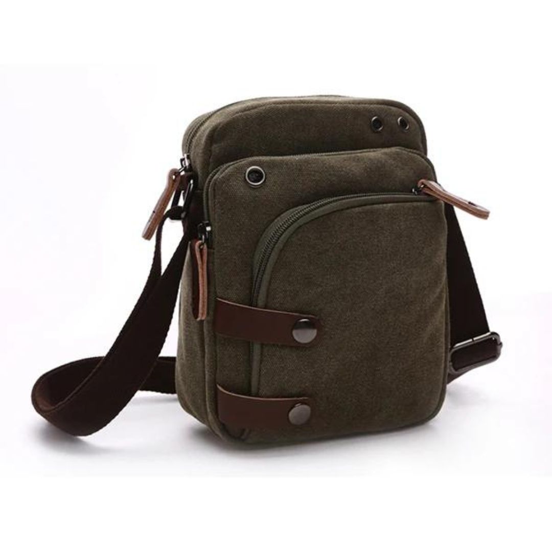 Bolsa de Ombro Masculina, confeccionada em lona resistente, sendo versátil para diversas ocasiões. Seu interior possui vários bolsos, incluindo um específico para celular, além de um espaçoso compartimento com fechamento em zíper. Com um estilo vintage, essa bolsa é perfeita para aqueles que buscam praticidade e estilo.
