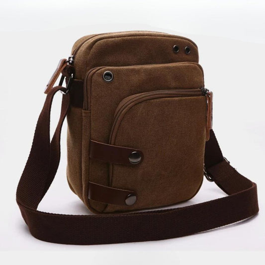 Bolsa de Ombro Masculina, confeccionada em lona resistente, sendo versátil para diversas ocasiões. Seu interior possui vários bolsos, incluindo um específico para celular, além de um espaçoso compartimento com fechamento em zíper. Com um estilo vintage, essa bolsa é perfeita para aqueles que buscam praticidade e estilo.