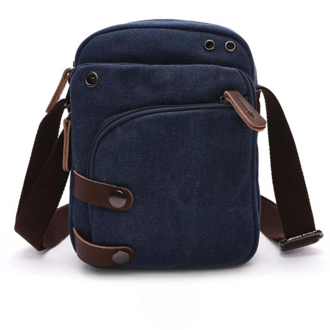 Bolsa de Ombro Masculina, confeccionada em lona resistente, sendo versátil para diversas ocasiões. Seu interior possui vários bolsos, incluindo um específico para celular, além de um espaçoso compartimento com fechamento em zíper. Com um estilo vintage, essa bolsa é perfeita para aqueles que buscam praticidade e estilo.